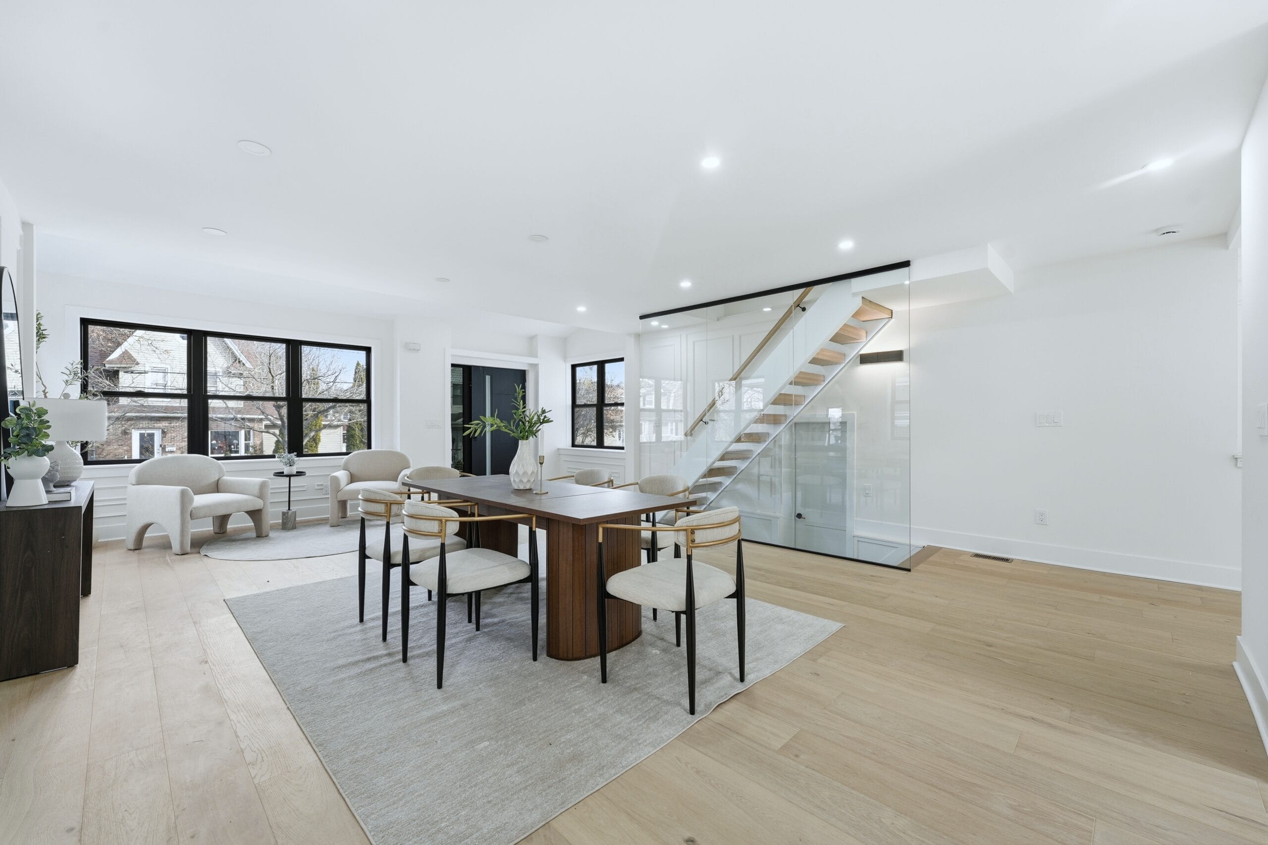 Bedroom with white oak floors and black-framed windows in the 820 Elm Avenue renovation