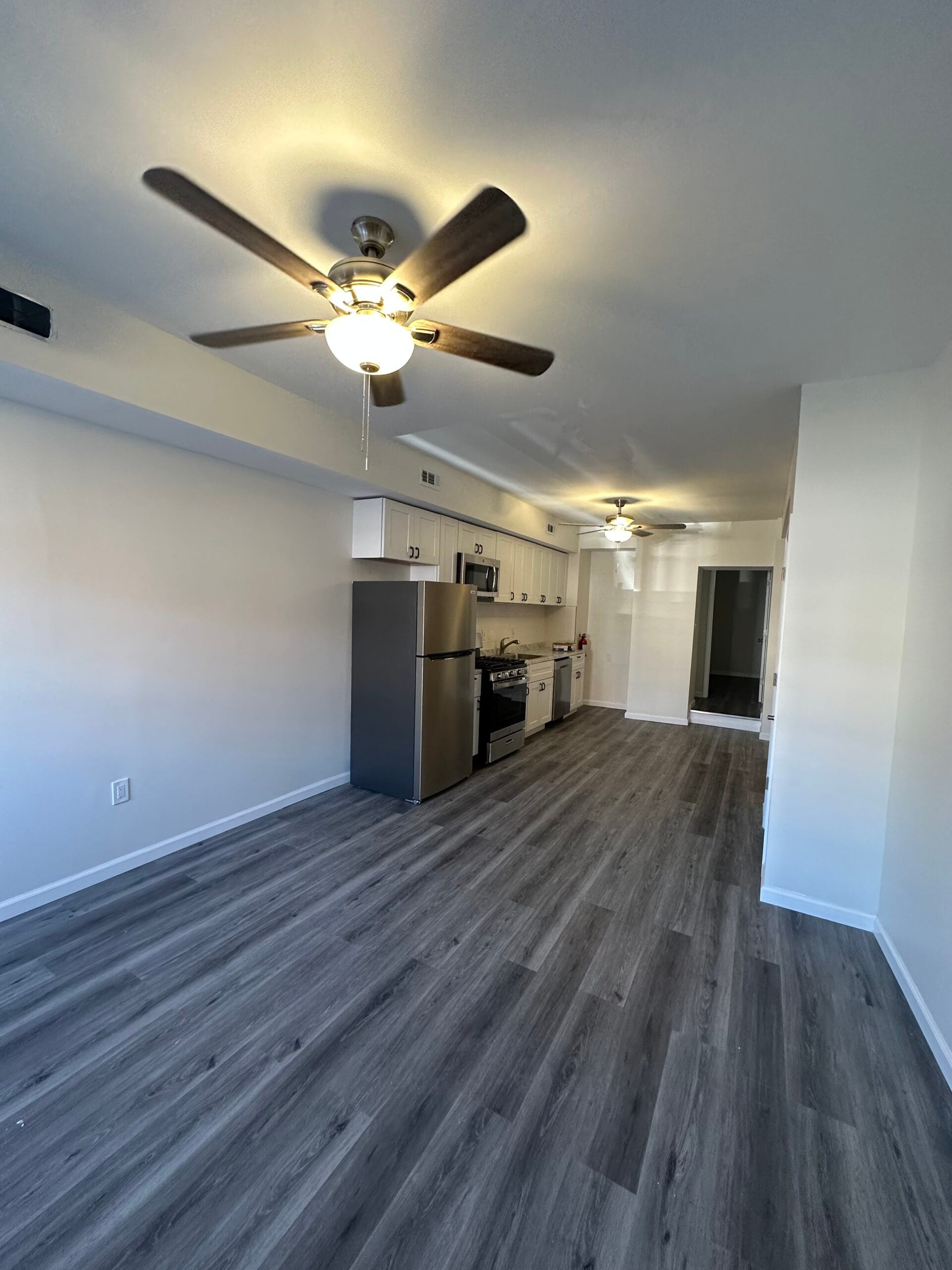 Open living and kitchen area in the Fairview remodel with new flooring