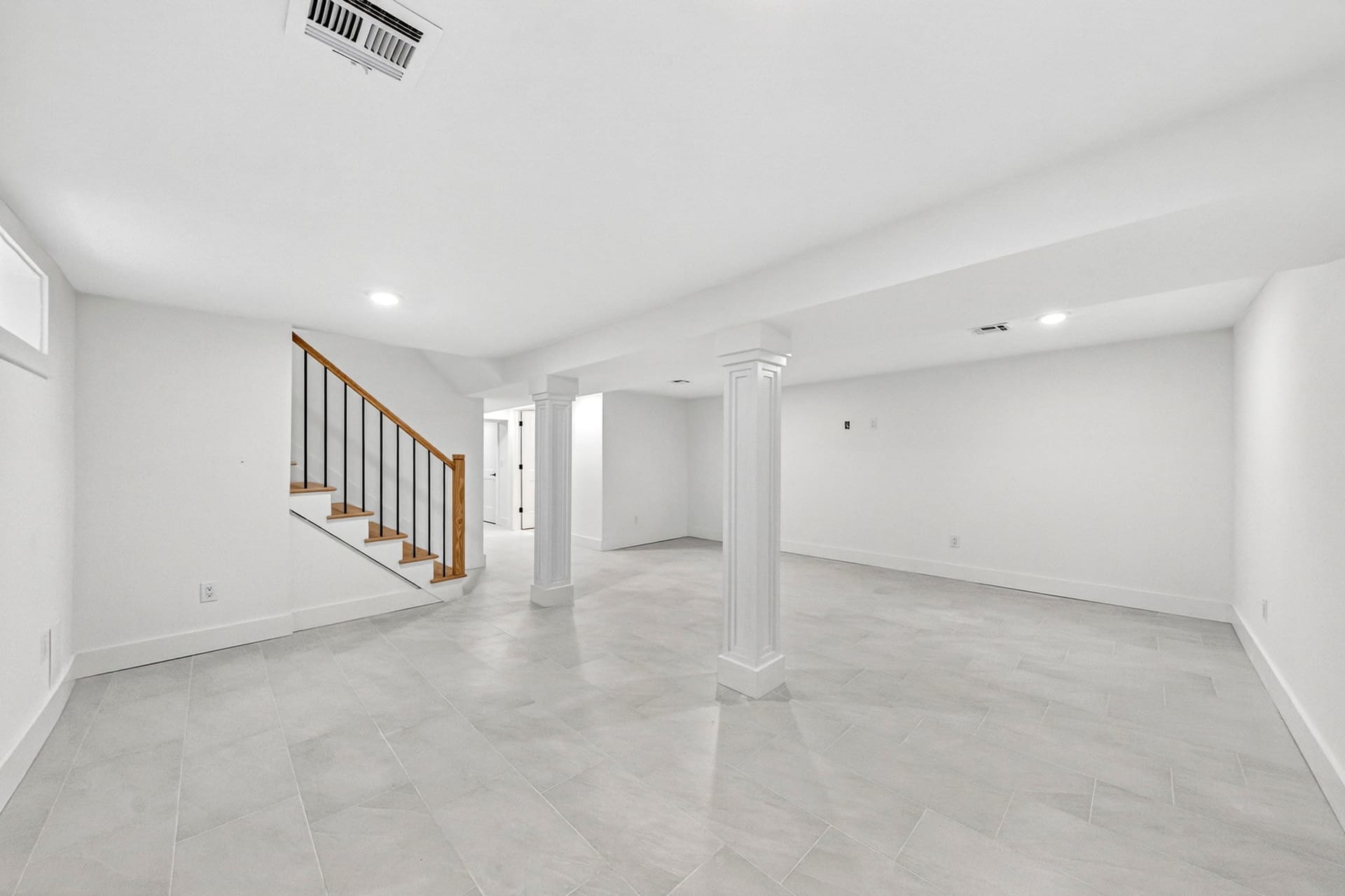 Basement recreation room open floor plan near the stairs