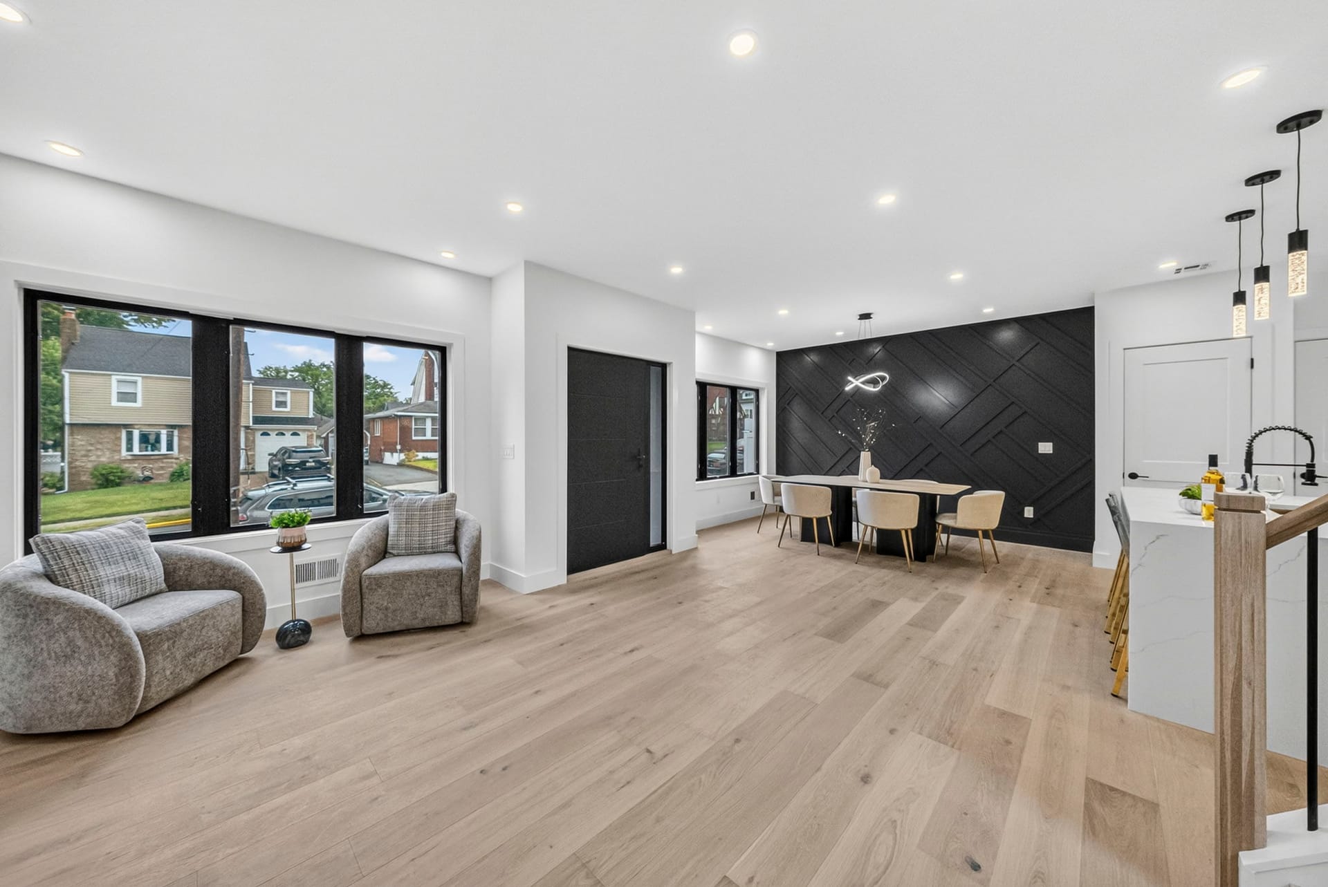 Living room with the dark accent wall and curved sofa