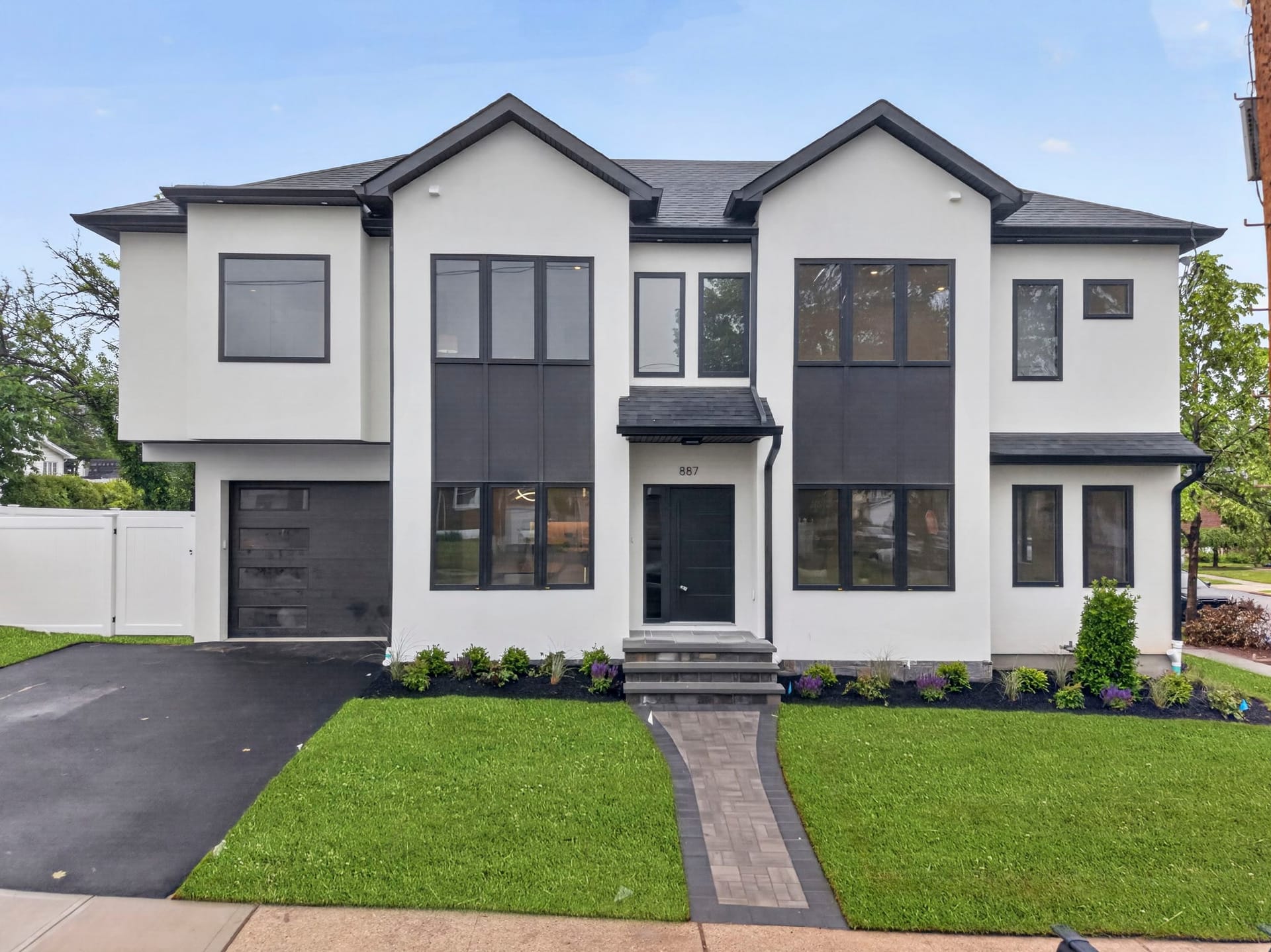 Front exterior of 887 Linden Avenue with landscaping and entry walkway