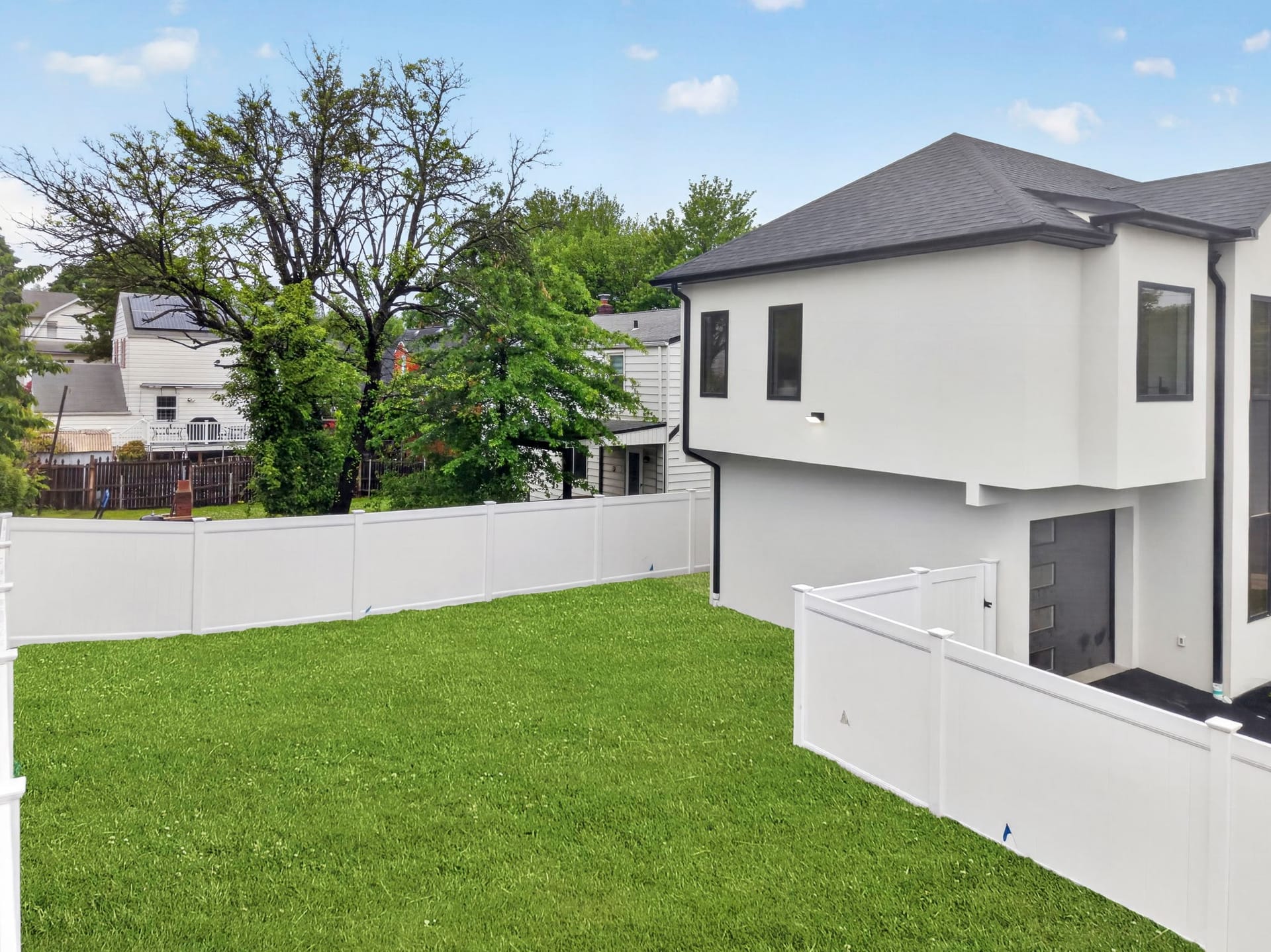 Rear exterior of the home with a fenced backyard