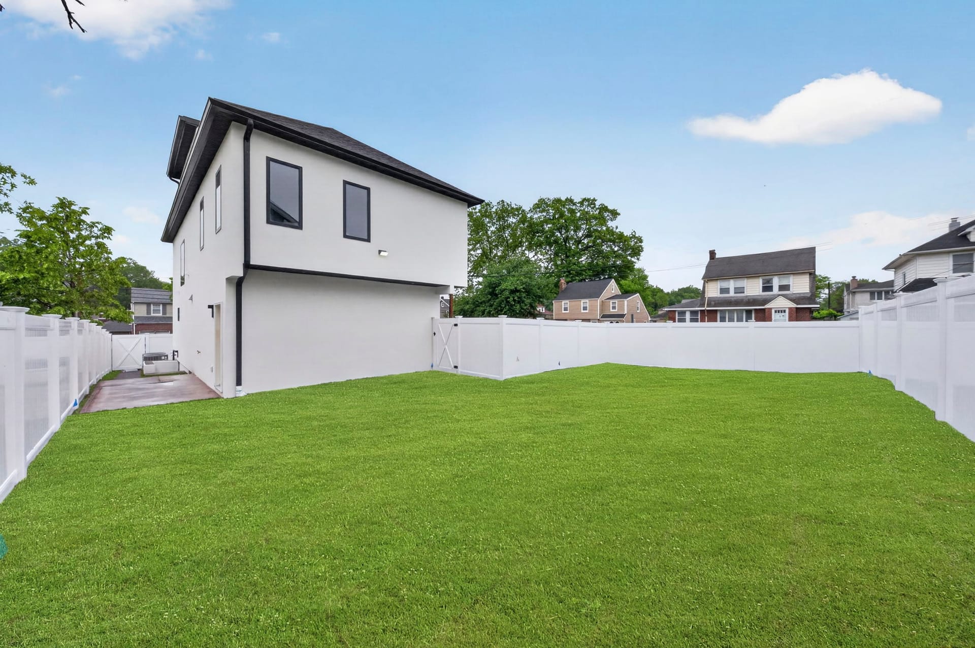 Side exterior view of the home with the fenced backyard