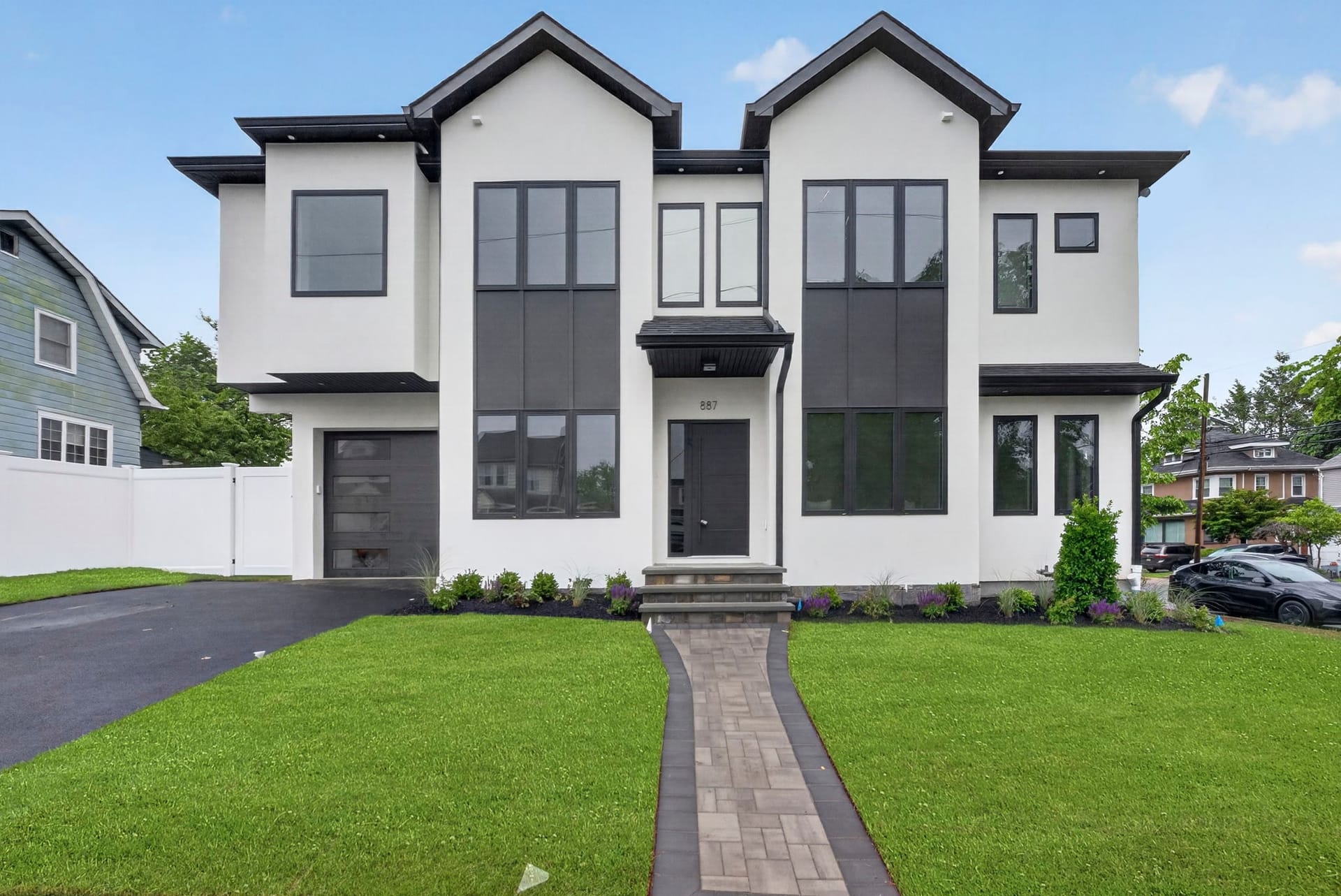 Front elevation of 887 Linden Avenue, a modern two-story home with white stucco and black trim